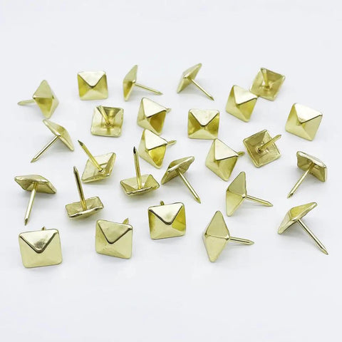 Real Deal Golden Square Upholstery Tacks Heavy Duty Shanks For Couch And Woodwork Revival 200 Pc Vintage Decorative Nail Kit laid out on white background.