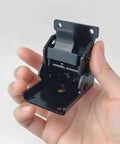 Close-up of a 90 Degree Self Locking Folding Hinge Lock Steel Foldable Bracket Hidden Hinge held in hand, showing size and design.