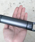 Hand holding Portable Survival Waterproof Pill Container For Outdoor EDC Gear, CNC Machined Aluminum Bottle, unbreakable and lightweight.