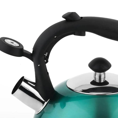 Close-up of a teal stainless steel whistling tea kettle, 2.3 liter, with ergonomic black handle and spout, ideal for fast boiling.