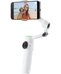 Flow 2 Pro Smartphone Gimbal With 3 Axis Stabilization And AI Tracking showing phone recording video of woman and dog on beach