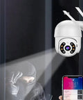Watch Your Back 270 Degree PTZ Security Camera 1080P HD Outdoor AI Human Detection Siren Alarm on a wall capturing a nearby intruder.