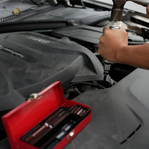 Using Half Inch Reversible Impact Driver Set Twelve Piece Hand Tool for loosing rusted screws in car engine with S2 steel bits