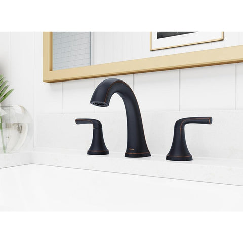 Ladera 8 Inch Widespread Two Handle Bathroom Faucet In Tuscan Bronze installed on a modern white countertop