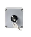 Front view of gray cast-aluminum push button switch control box with keyed lock and two keys.