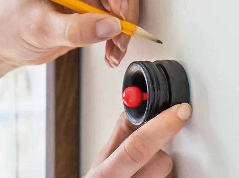 Person using magnetic stud finder no batteries no calibration 3X more reliable for lath and plaster with indicator on wall