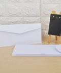 Twenty Pack White Blank Envelopes With Reusable Design for Mail Document Storage Office Supplies and Party Invitations shown on table