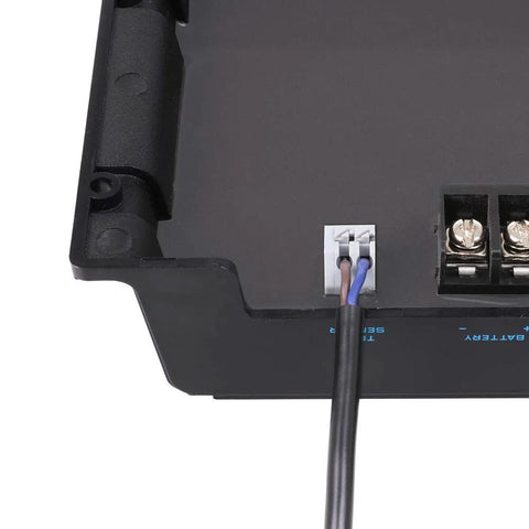Close-up of Renogy battery temperature sensor with white connector and brown/blue leads on a black solar controller