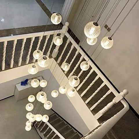 Sleek Modern Stair Chandelier Featuring Glowing Round Glass Balls And White Metal Frame For Dramatic Ceiling Pendant Lighting That Drops Major Vibes In Your Living Room Or Hallway Setup, overhead view with multiple glass balls.