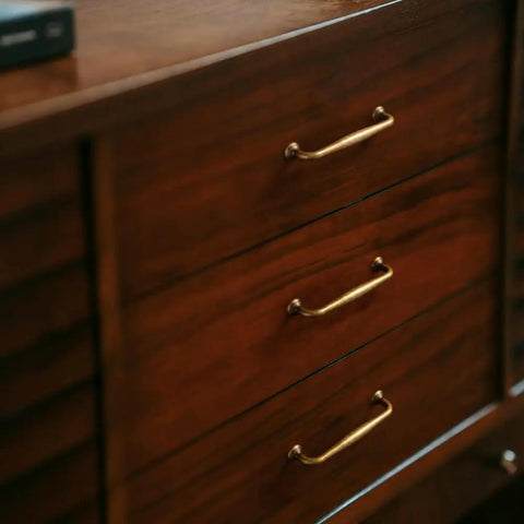 Antique Brass Cabinet Pulls Set Of Twelve Vintage Zinc Alloy Drawer Handles on wooden dresser, 5 inch length, old school vibe