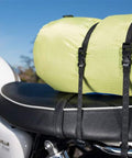 Beefy Heavy Duty Reflective Adjustable Cargo Stretch Strap For Motorcycles And ATVs 18 To 60 Inch 100 Lb Capacity securing a bag on a bike