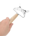 Stainless steel dumpling cutter with wood handle held in hand, part of three piece set for quick shaping of dumpling wrappers.