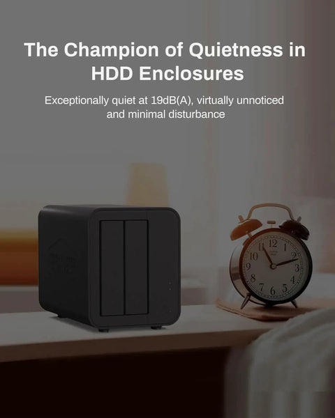 Rock Solid Hybrid Nvme Sata Enclosure hosting two hard drives with quiet design on a bedside table beside an alarm clock.
