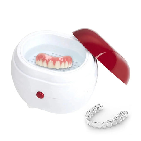 Portable Ultrasonic Denture And Retainer Cleaner Case With Automatic Wash Feature And Built In Filter For Glasses Jewelry And False Teeth Compact Straight Up Spotless Daily Essential with dentures and retainer in water.