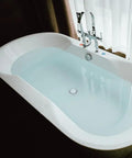 Hair Stopper Catcher Anti-Clogging Bathtub Drain Stopper with Strainer in a modern white bathtub filled with water.