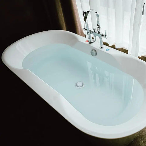 Hair Stopper Catcher Anti-Clogging Bathtub Drain Stopper with Strainer in a modern white bathtub filled with water.