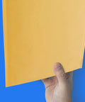 Hand holding 14.5 X 20 Inch Kraft Bubble Mailers Pack Of 50 Self Sealing Padded Envelopes for secure shipping.
