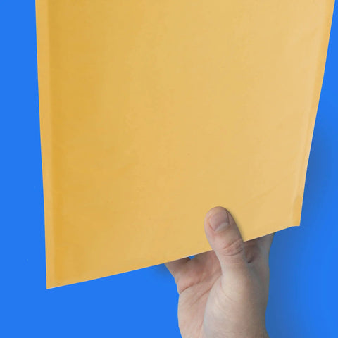 Hand holding 14.5 X 20 Inch Kraft Bubble Mailers Pack Of 50 Self Sealing Padded Envelopes for secure shipping.