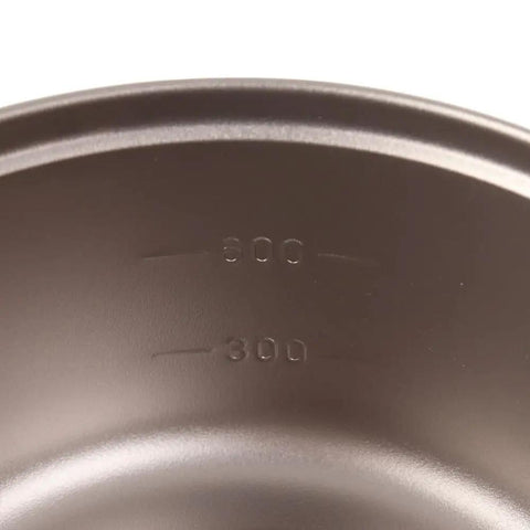 Close-up of Ultralight Titanium Camping Pot With Folding Handle, 900 Ml Capacity, inside volume markings visible.