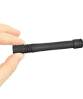 Hand holding UHF Stubby ATU 6DS Antenna for VX Series Radios, compact 3.7 inch black antenna, side view