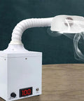 Built Tough Solder Fume Extractor Kicking Welding Vapor And Shop Dust To The Curb With Multilayer Carbon Filtration and Breezy Speed Controls, showing the machine with a flexible arm and smoke.