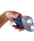 Hand holding a blue Hand Crank Emergency Flashlight Four Pack Rechargeable Crank Light With Dual LED For Camping Car Travel