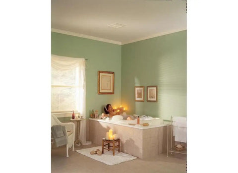 Quiet Low Noise Ceiling And Wall Ventilation Fan, 50 CFM, 4.0 Sones installed in a serene bathroom with tub and candles