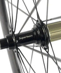 Close-up of hub on 50mm 23mm Carbon Road Wheelset 700c Clincher For Aero Performance, Matte 3K Braking Surface, lightweight wheel.