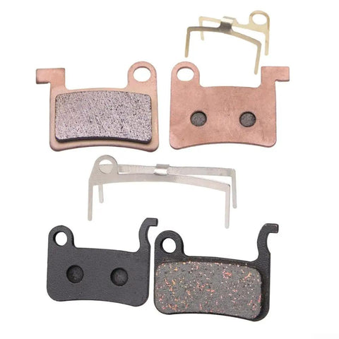 Beefy Semi Metal Ceramic Bicycle Disc Brake Pads For Hydraulic Calipers All Metal Sintered For Grippy Stopping Power On Downhill Trail Riding In Wet Or Dry Conditions, with hardware and clips visible