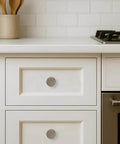 Rad 1 Inch Brushed Antique Brass Cabinet Knobs 5 Pack With Badass Grip And Fluted Design For Kitchen Cabinets And Bathrooms Solid Vintage Hardware That Is Totally Fire And Cool, shown on white drawers.