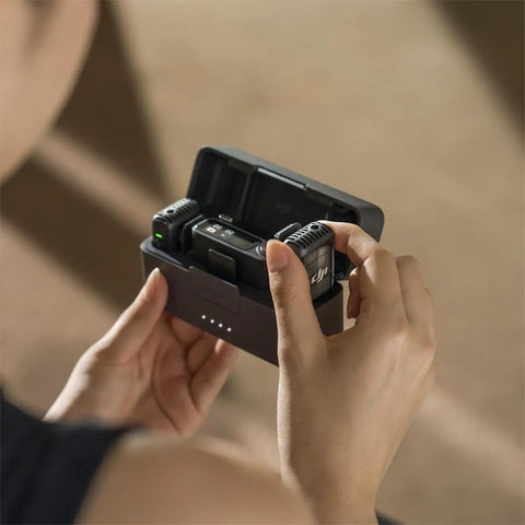 Person holding the Plug-And-Play All In One Wireless Microphone System With 2 Transmitters And 1 Receiver in charging case