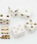 Five white ceramic 2‑pole terminal blocks with brass screws for high‑temperature electrical wiring