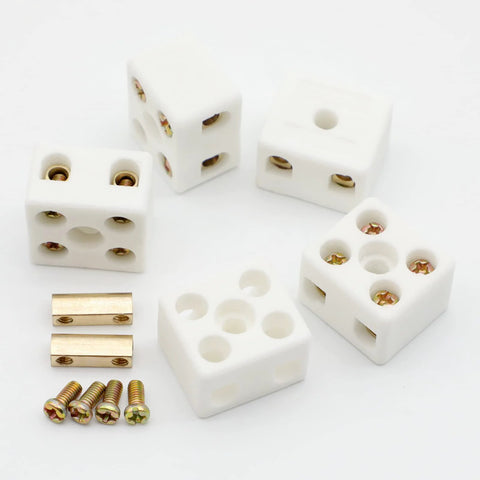 Five white ceramic 2‑pole terminal blocks with brass screws for high‑temperature electrical wiring