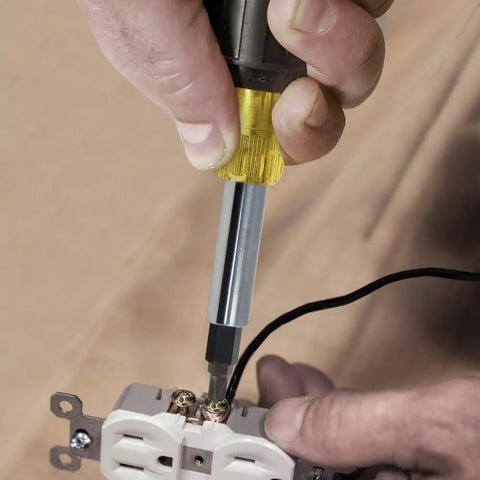 Heavy Duty 10 In 1 Multi Bit Screwdriver Nut Driver With Interchangeable Shafts and Six Universal Tips being used on outlet