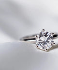 Close-up of a silver diamond ring on a soft surface. Ultra Concentrated Ultrasonic Jewelry Cleaner Solution For Home Use Delivers Killer Deep Clean For Rings Watches Glasses Earrings Coins Works With Diamond Gold Silver 1 Quart Mix With Water.