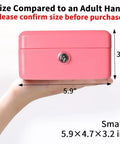 Small Pink Cash Box With Key Lock Double Layer Metal Money Box For Home Security shown in an adult hand for size reference