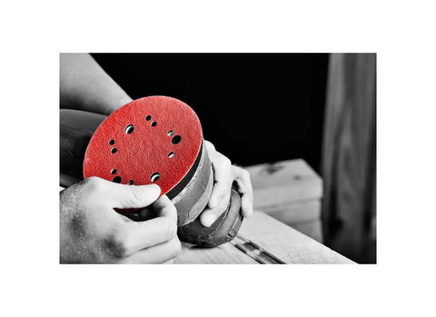 Hands holding sander with red Hook And Lock ROS Sanding Discs For Wood Metal And Plastics 5 Inch 60 Grit Coarse Ceramic Blend