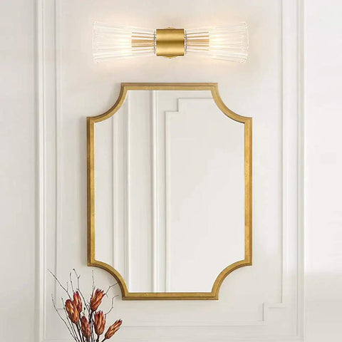 Mid Century Modern Crystal Glass Shade 2 Light Gold Brushed Brass Wall Sconces in bathroom with gold framed mirror