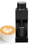 Top Shelf Single Dose Electric Coffee Grinder With 38mm Conical Burrs And Stepless Dial 30G Hopper next to a latte on a white plate.