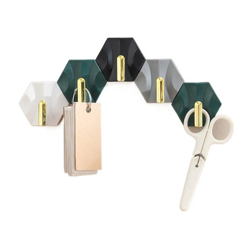 Sleek Adhesive Wall Hooks 4 Pack With Super Tough Grip Tape for hanging tags and scissors on a decorative hexagon wall mount.