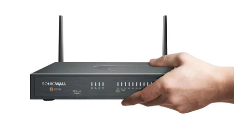 Rock Solid Plug And Play Next Generation Firewall With 2.5 GBPS Throughput And One Year TotalSecure Advanced License held by a hand.