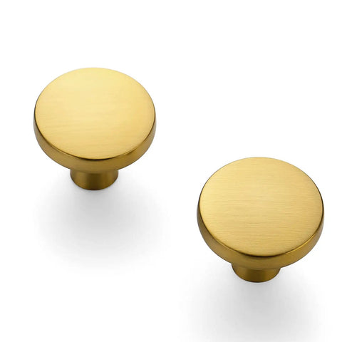 Heavy Gauge Brushed Brass Cabinet Knobs 5 Pack Featuring Smooth Round Edges And Top Shelf Solid Build To Fast Track Your Kitchen Remodel And Make Every Drawer Look Absolutely Sick, close-up view of two knobs.