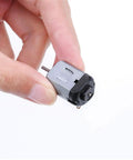 Hand holding a mini DC motor with 10x2mm shaft, part of Six Pack Mini DC Motors 0.5-3V 15000RPM For DIY Toys And Science Projects