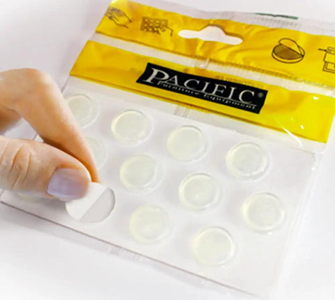 Clear Silicone Glass Table Bumpers Deliver A Snug Anti Slip Fit That Really Locks Furniture Down And Kills That Annoying Slide Heavy Duty Adhesive, 16mm pads being peeled from pack.