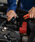Person using 16 Foot Heavy Duty Jumper Cables 6 Gauge Automotive Booster Cables to connect battery terminals in vehicle engine.