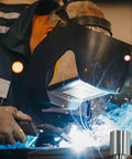 Welder using welding table with 12 Pack Welding Table Fixture Pins Five Eighths By One By One Point Five Inches Aluminum Quick Setup Fixturing Kit