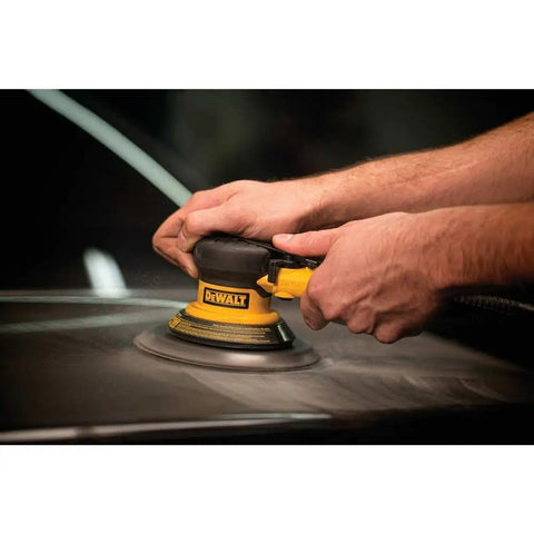 Palm Air Sander 12000 RPM Pneumatic Sander with Quick Change Pad being used on auto body surface by two hands in a workshop