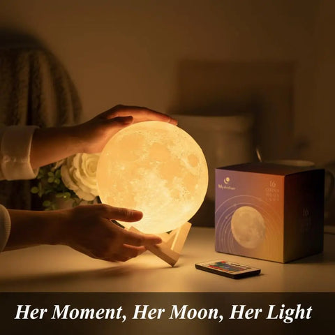 Hands holding a Large Moon Lamp 7.1-Inch With Wooden Base, Touch Dimmable Dual Color Night Light on a table