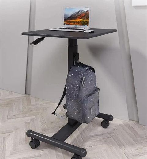 Smooth Casters Let You Slide This Beast Anywhere Upgrade Your Daily Grind With Height Adjustable Mobile Standing Desk with laptop and backpack.