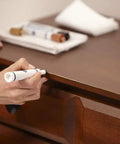 Fire DIY Wood Furniture Scratch Repair Kit With Three Touch Up Markers And Wax Filler Sticks For No Sweat Scuff Control On Cabinets And Table Surfaces In Brown being applied to a wooden table.